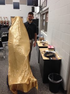 "Mr. Harrel pulling the mannequin into the PAC for the uniform unveiling."